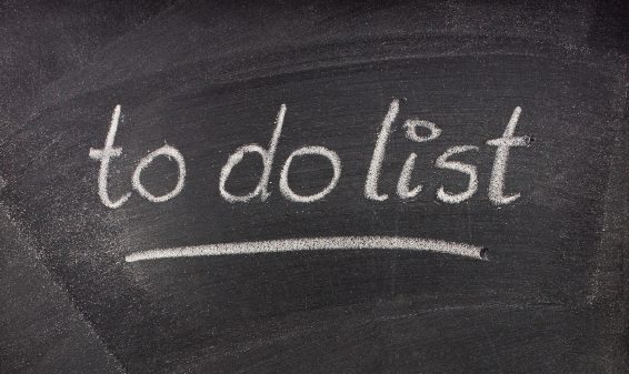writing on chalkboard training how to prioritize tasks with a to do list